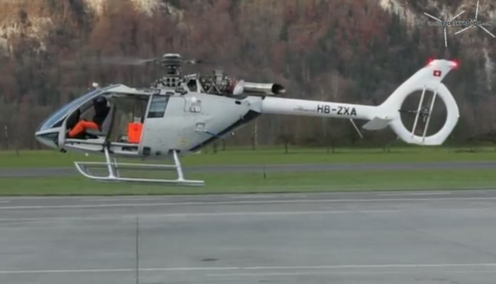 Left side of HB-ZXA, engine compartment open, of the Marenco SwissHelicopter SKYe SH09