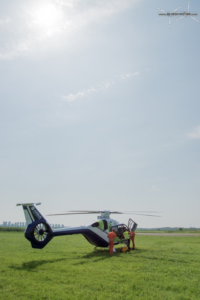 Bluecopter between the green grass and the blue sky